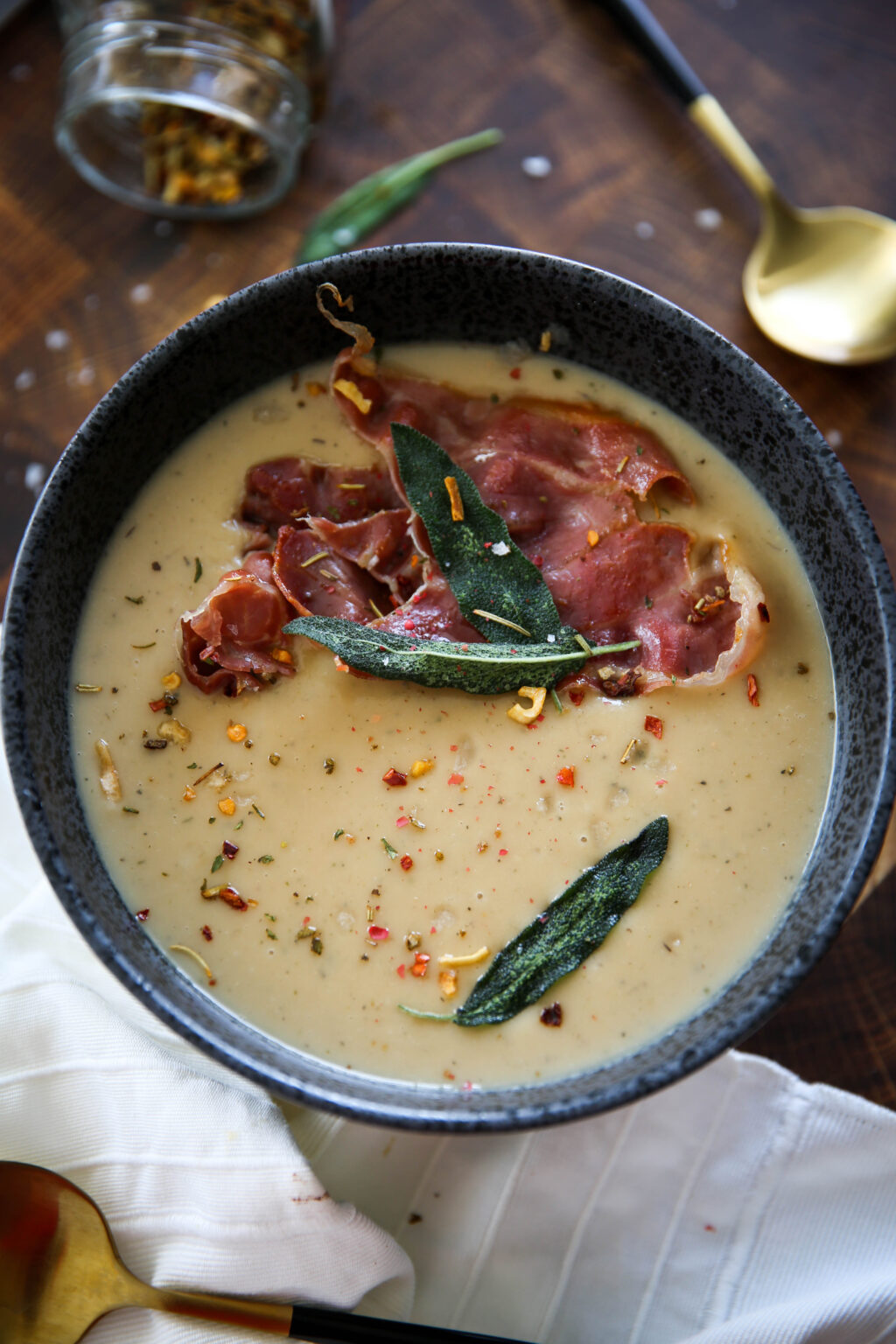 Hearty white bean soup with fresh herbs and garlic in a rustic bowl